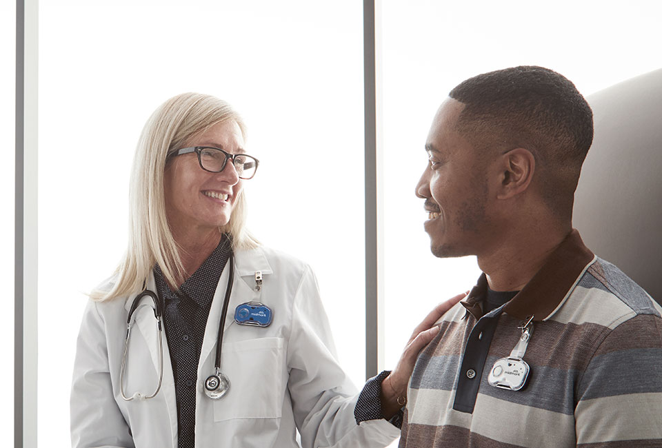 Doctor with hand on patient's shoulder