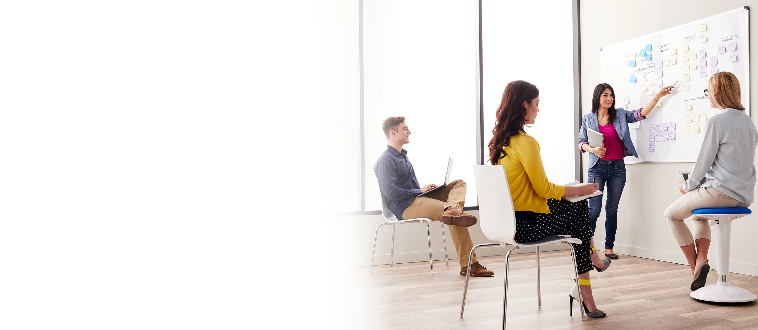 three people looking at whiteboard during onsite training