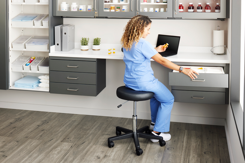 Pharmacy_Room_Vet_Tech_Seated_Reaching_Base_Cabinet_Right