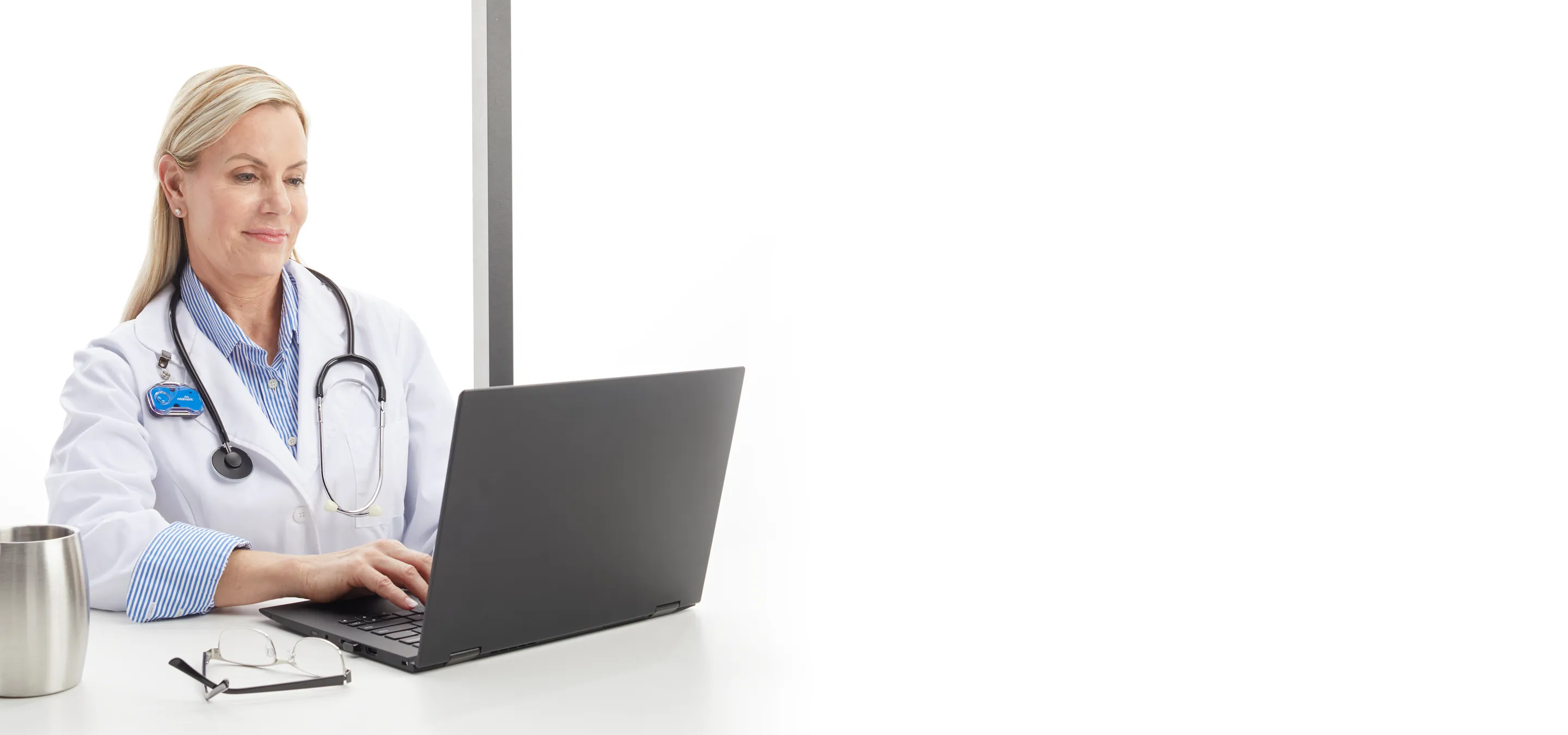 doctor typing on laptop