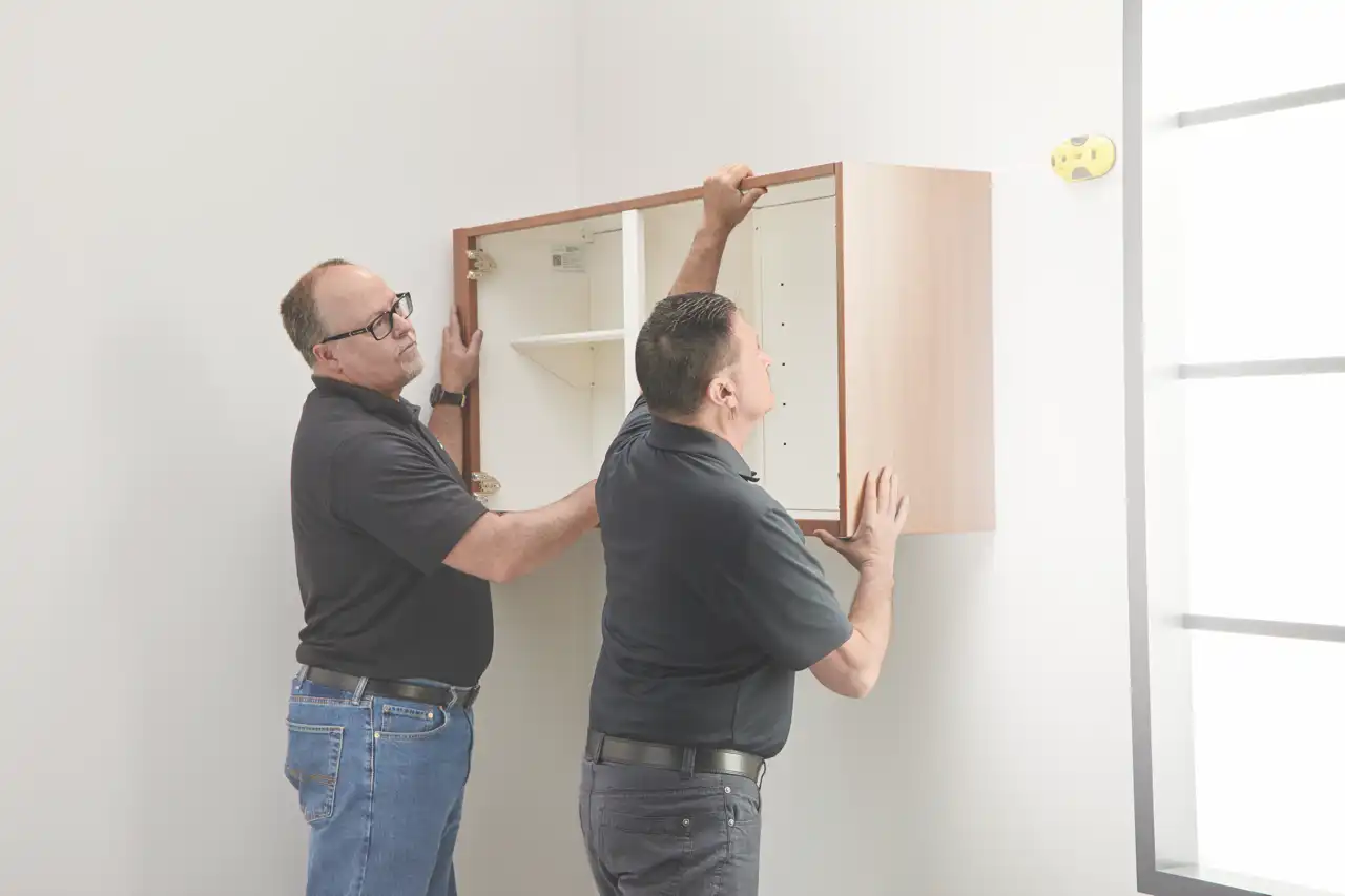 Hanging upper cabinet with two installers