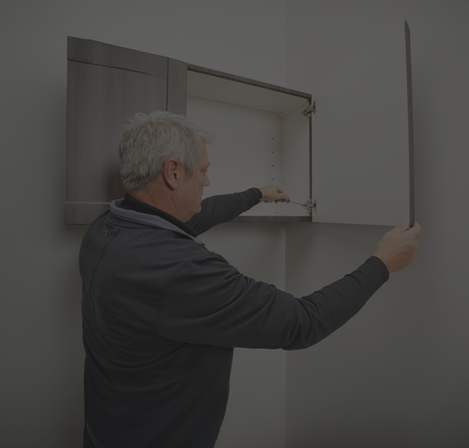 Man installing Midmark Cabinetry