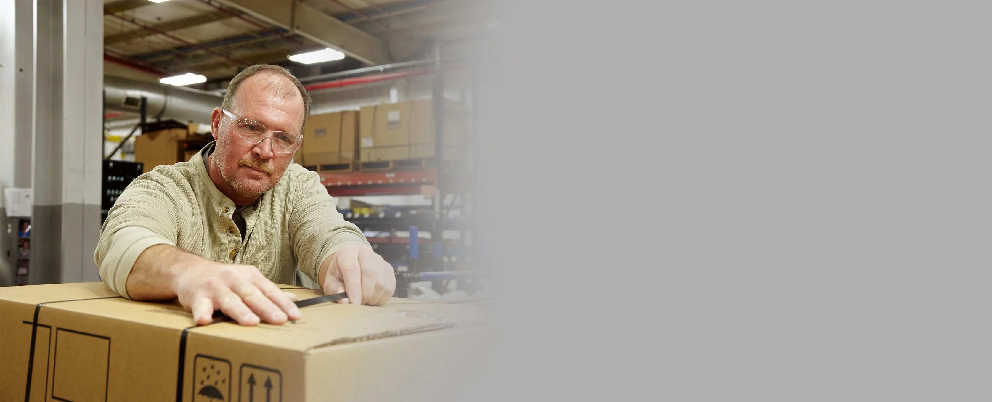 midmark manufacturing teammate sealing a box