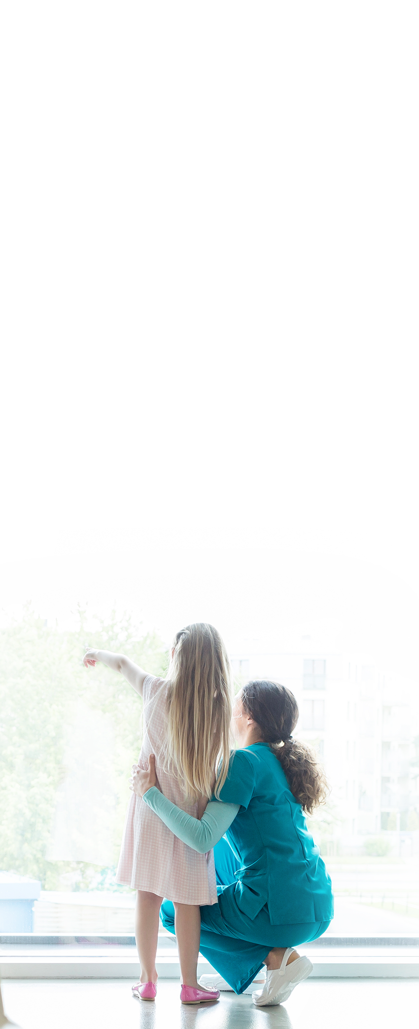 Nurse with child looking out window