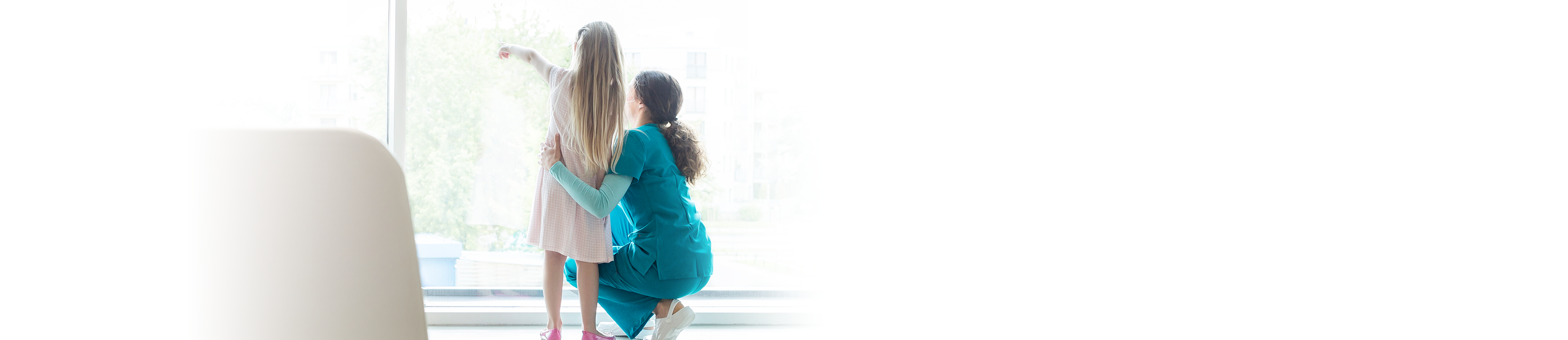 Nurse with child looking out window