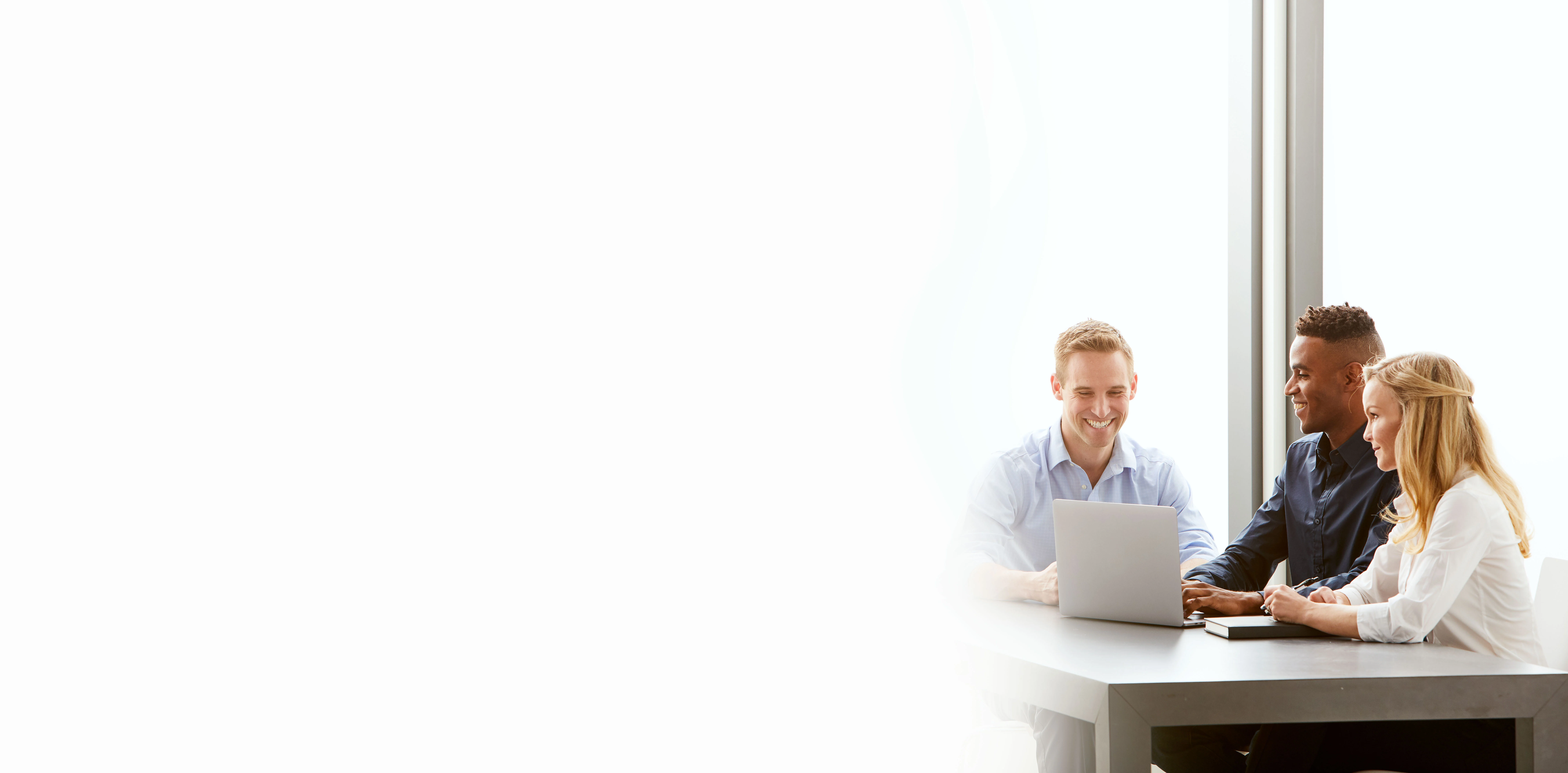 three midmark teammates looking at computer