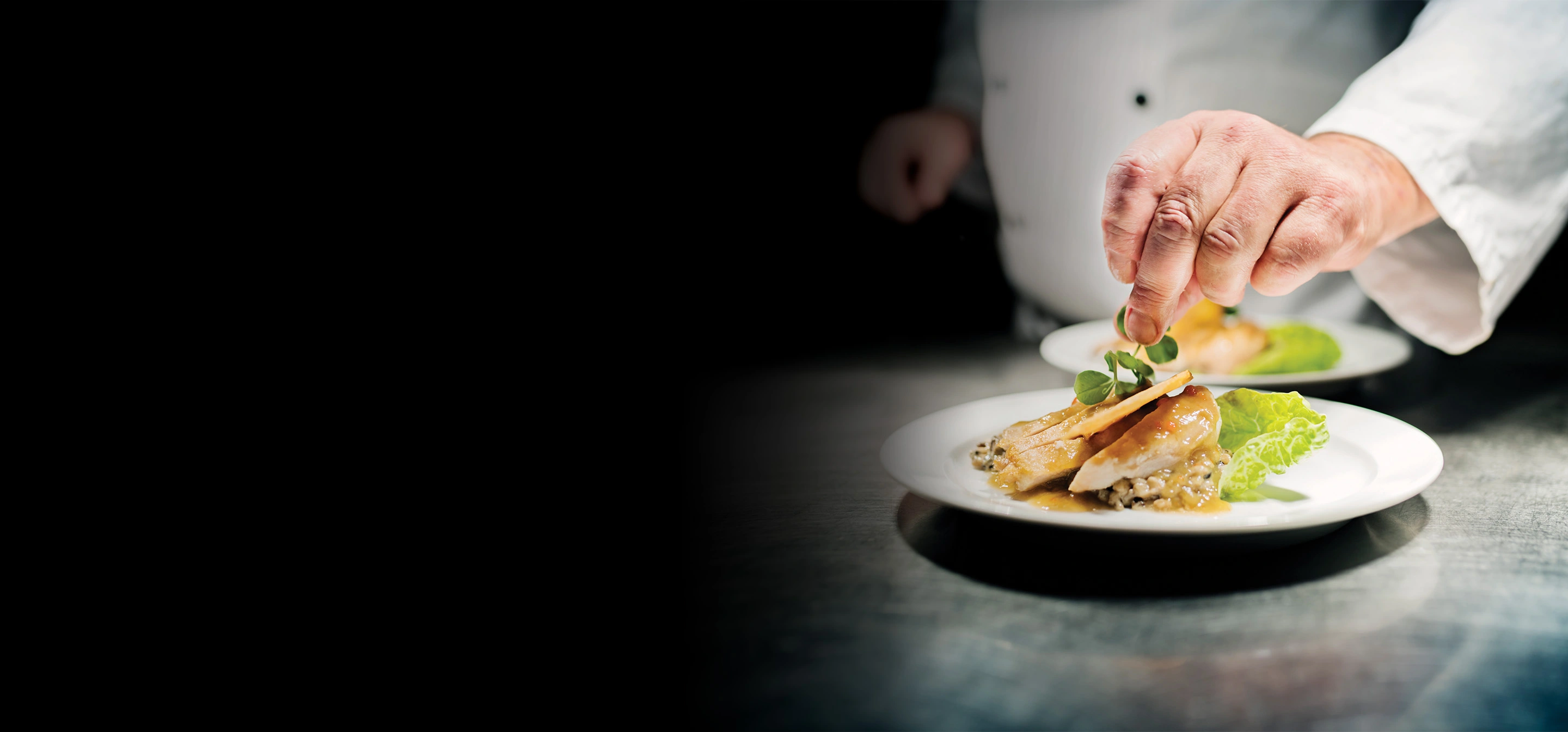 chef garnishing plate at silas creative kitchen