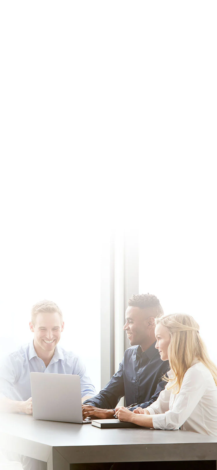 three midmark teammates looking at computer