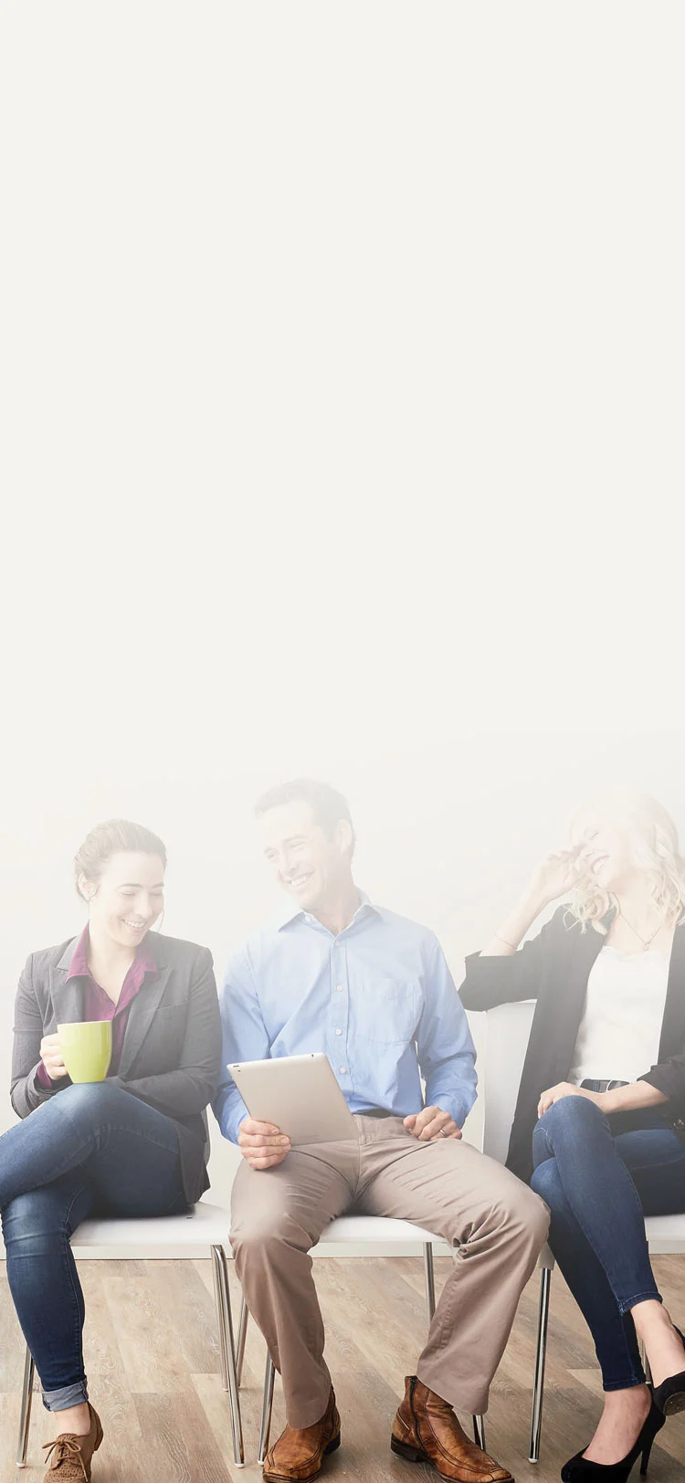 three midmark employees laughing at a tablet