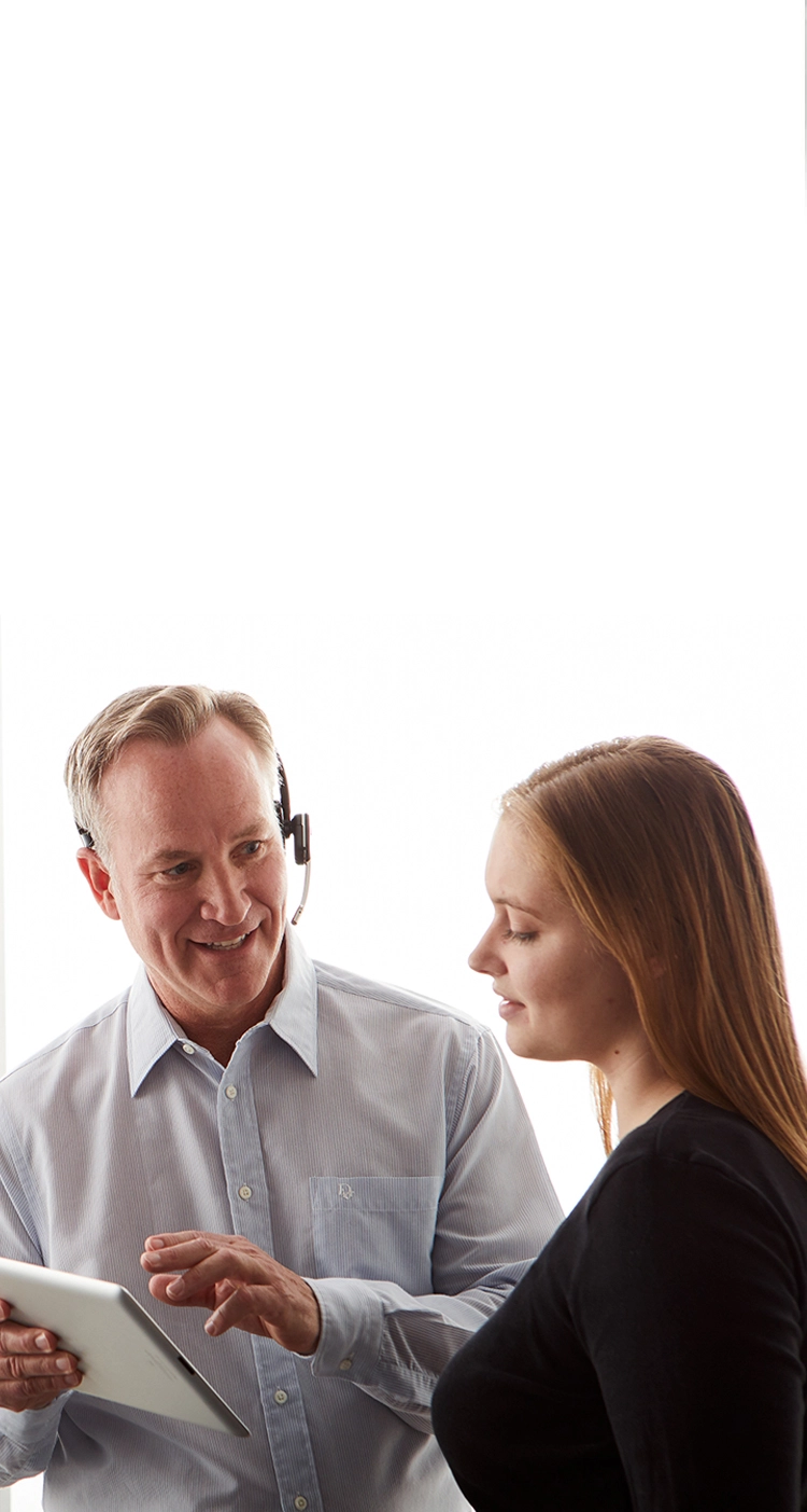 man talking to woman while holding tablet