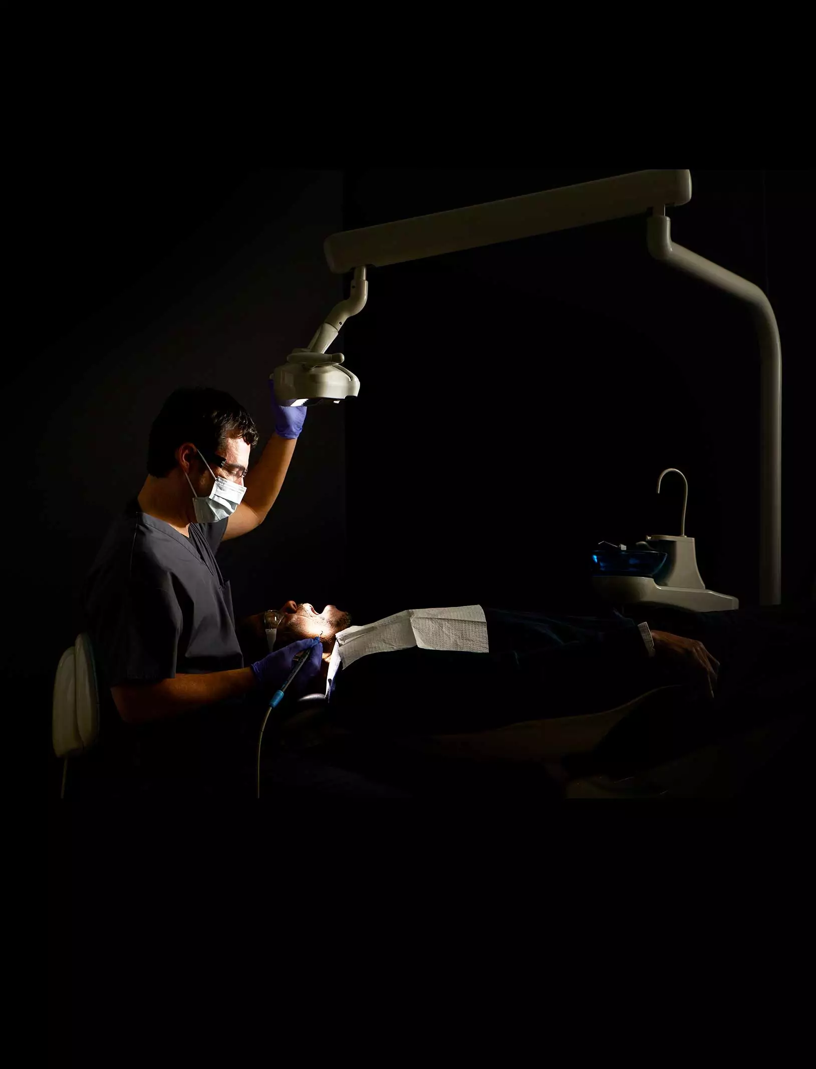 dentist with patient during checkup with midmark dental light