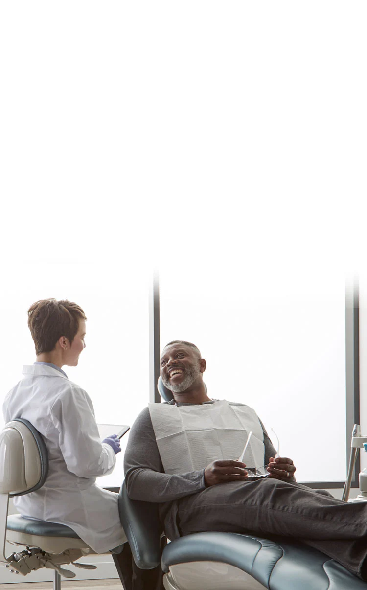 dentist helping patient sitting in midmark dental chairs