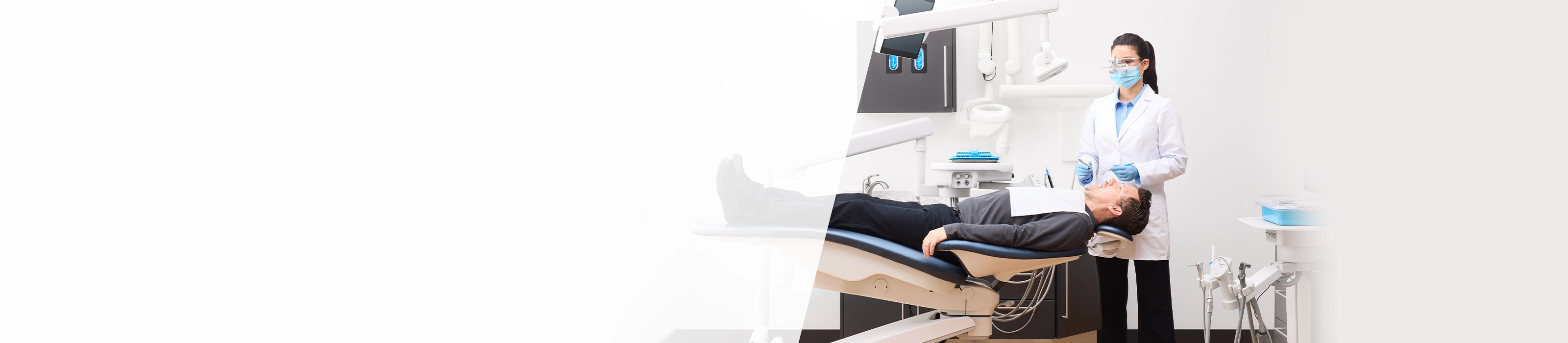 dentist helping patient sitting in midmark dental chairs