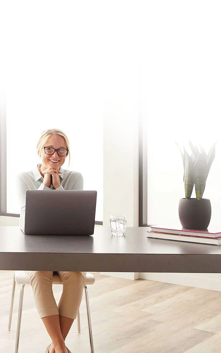 employee sitting at desk with laptop