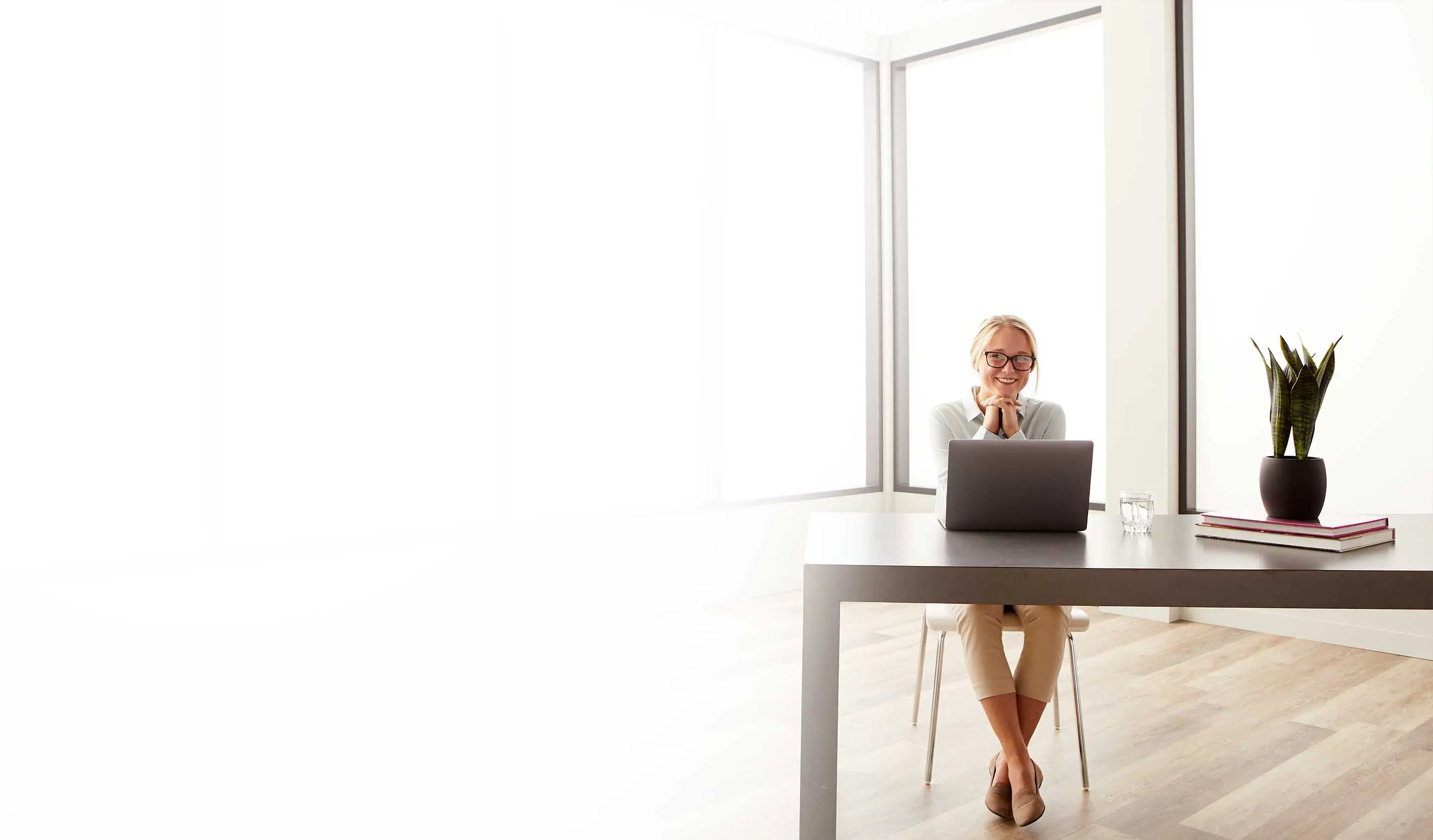 employee sitting at desk with laptop