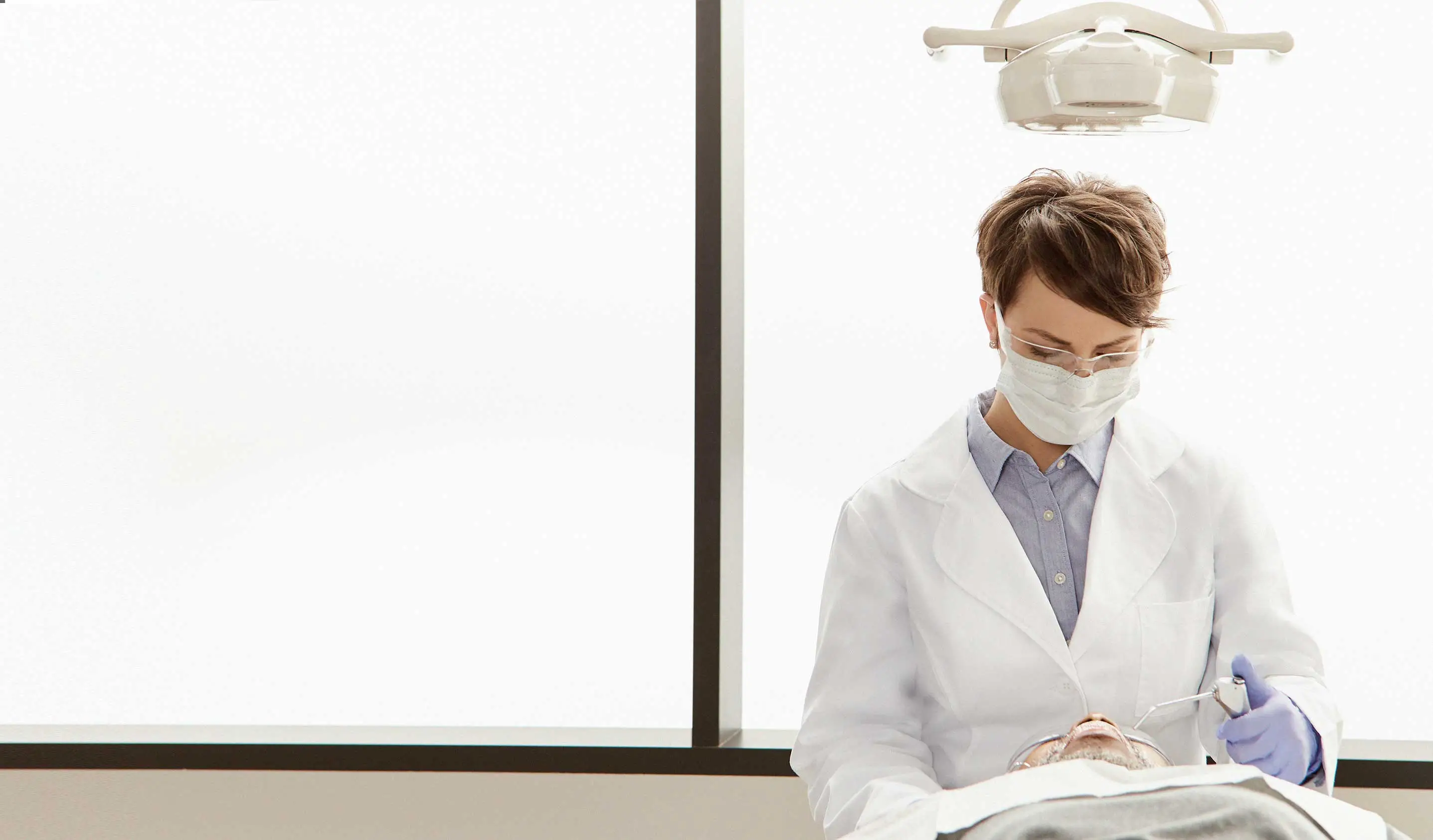 dentist cleaning patient's teeth