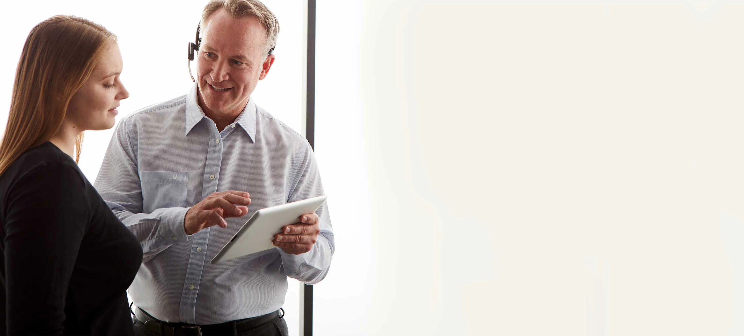 midmark employee holding a tablet and helping customer