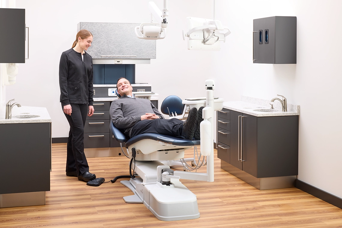 2026-june-blog-2-image-patient-comfort Patient reclining comfortably in a Midmark Dental Chair while a dental professional prepares for treatment in a modern operatory.