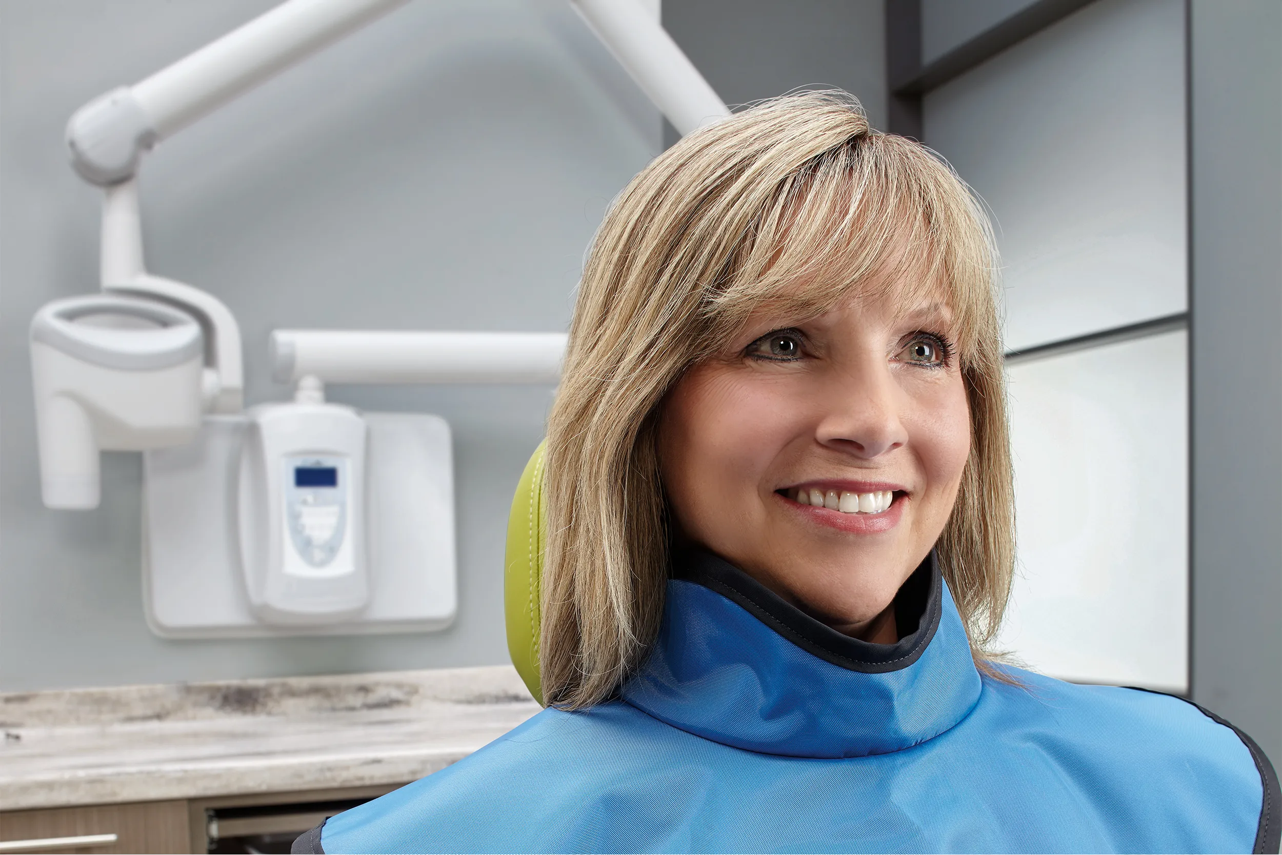Patient wearing lead apron after intraoral imaging with a dental X-ray unit in a dental clinic
