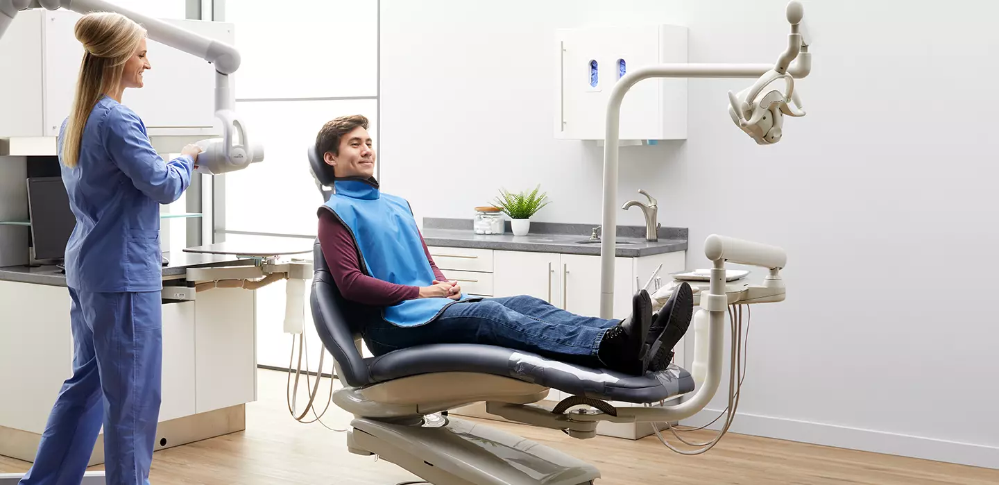 patient sitting in dentists chair