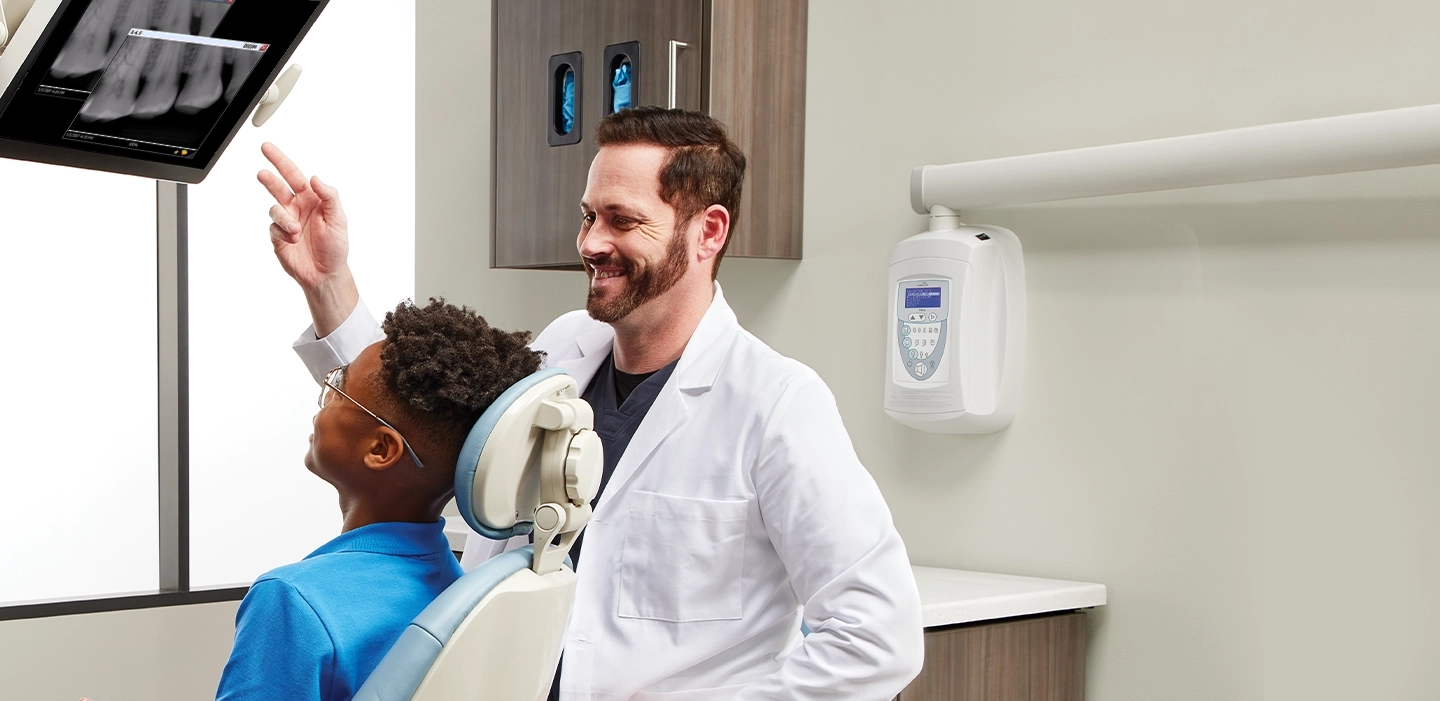 dentist showing x-rays to a child patient