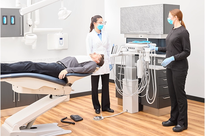 ProductPage-MidmarkDeliverySystem-img10-high-side-dentist-hygeinist-adult-patient-column-mounted-delivery-system-touchpad-handpieces-set