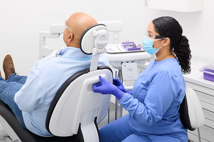 ProductPage-MidmarkDentalChair-img9-entry-hygienist-adult-patient-adjusting-backrest