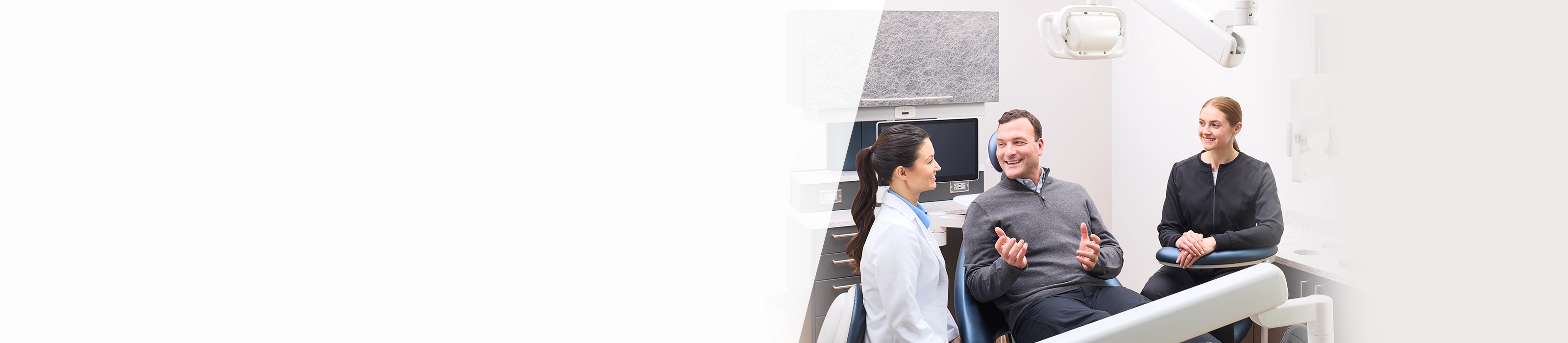 dentist adjusting dental light on patient