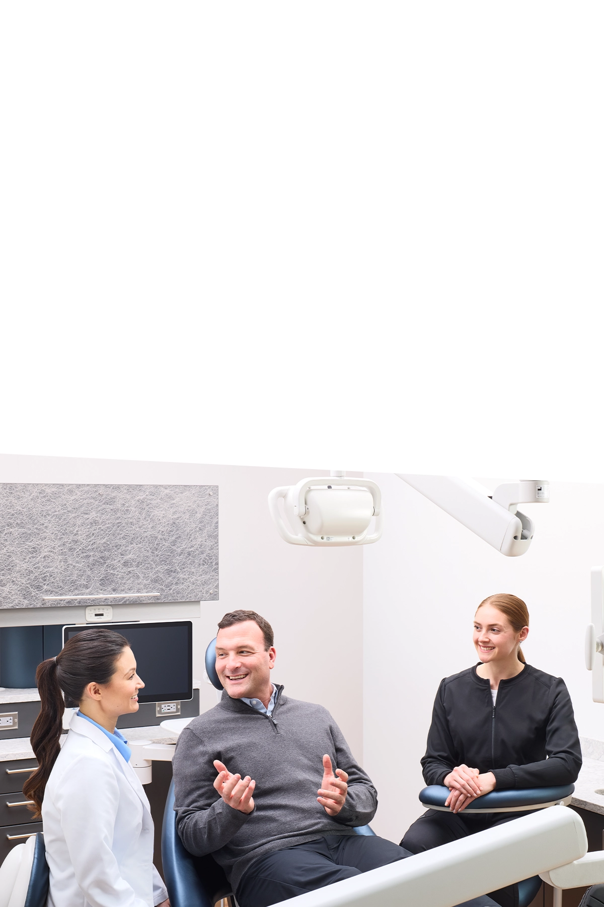 dentist adjusting dental light on patient