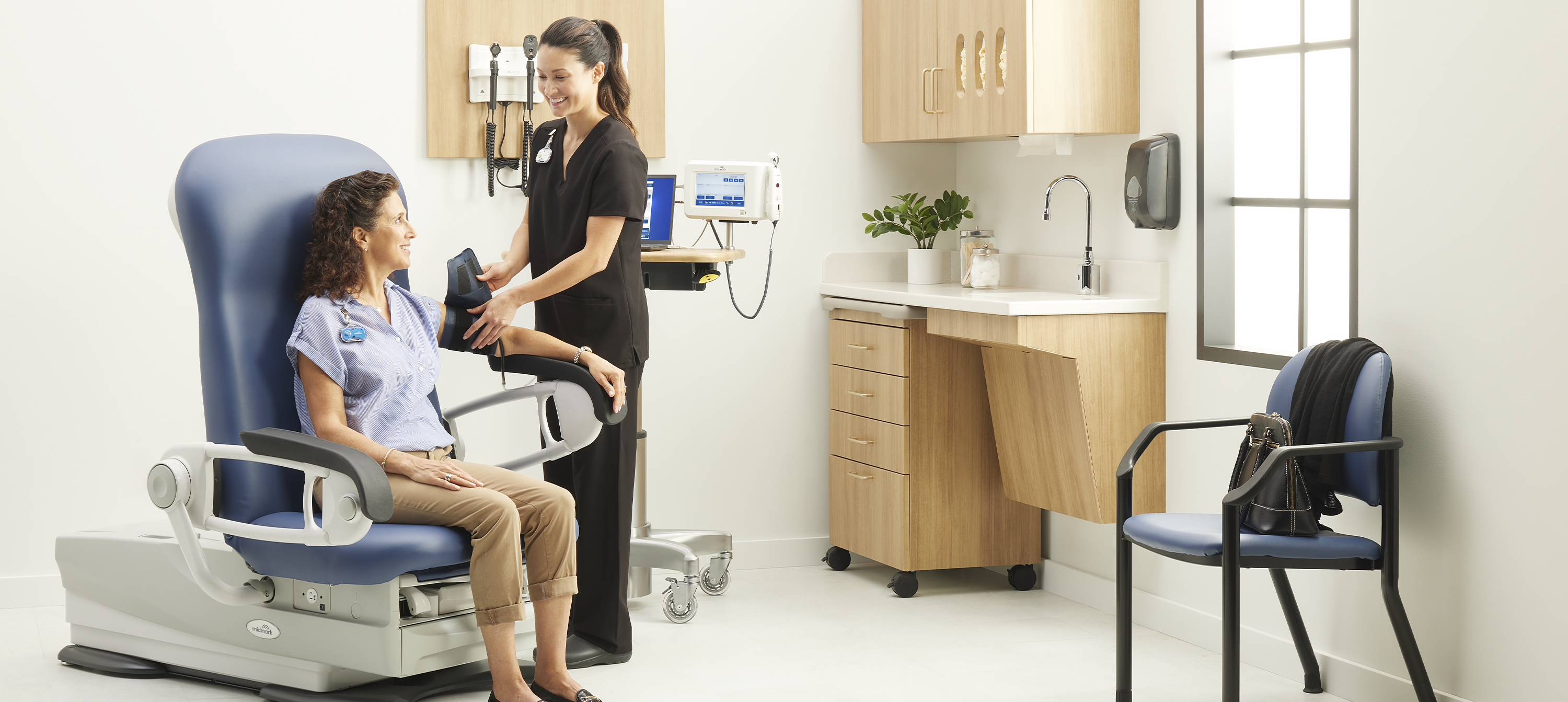 Nurse checking blood pressure on patient