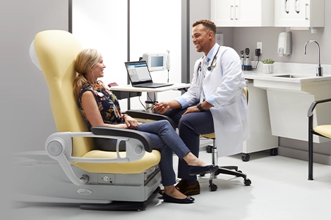 Doctor speaking with patient sitting in a Midmark 626 Exam Chair