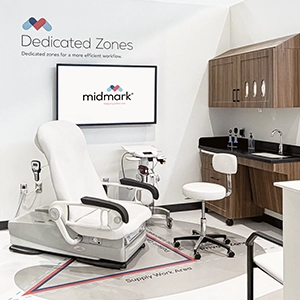 Midmark showroom display demonstrating a dedicated zones medical exam room layout with printed floor markings to optimize workflow efficiency.