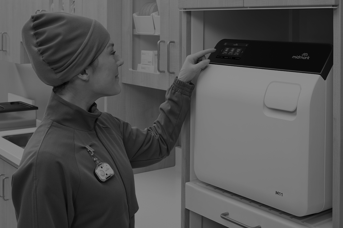 MA starting a cycle on the Midmark Steam Sterilzier