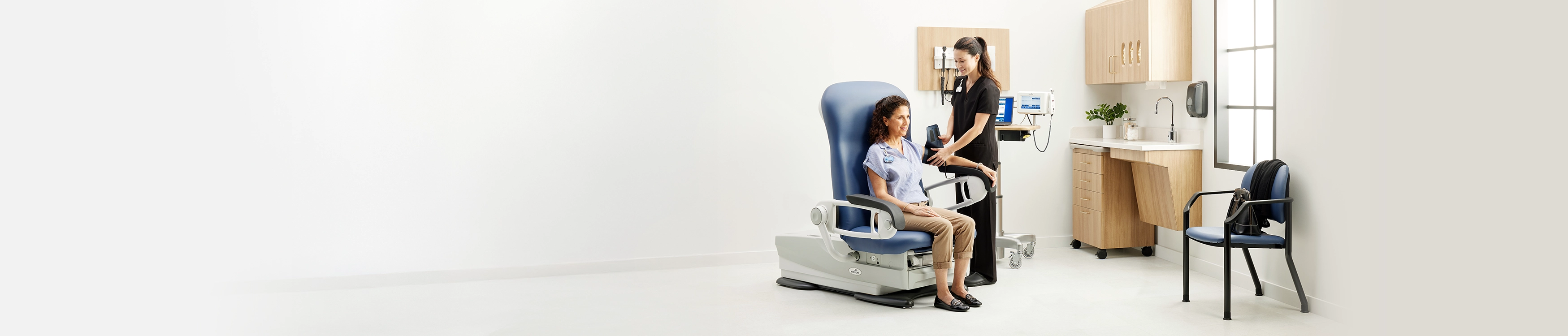 MA placing BP cuff on patients arm