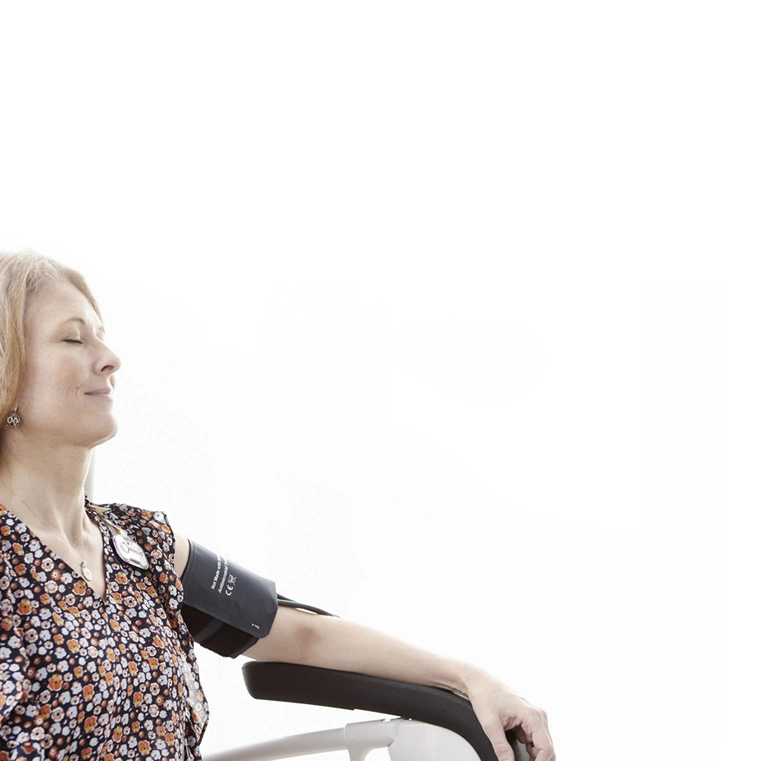 patient in chair with blood pressure cuff