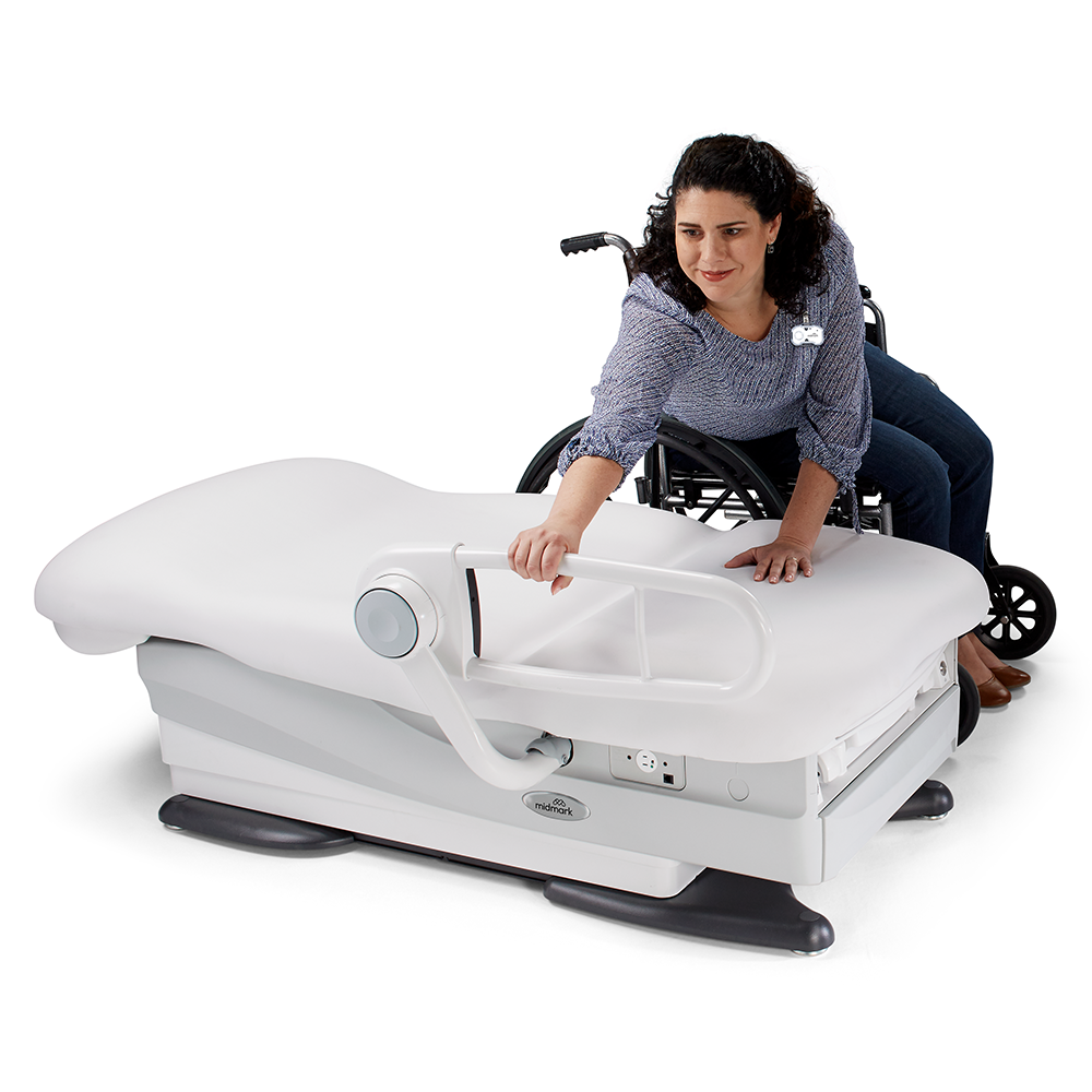 Patient in wheelchair beginning the transfer into the 626 while it's in flat position