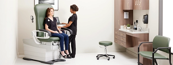 MA weighing patient in Midmark 626 Exam Chair