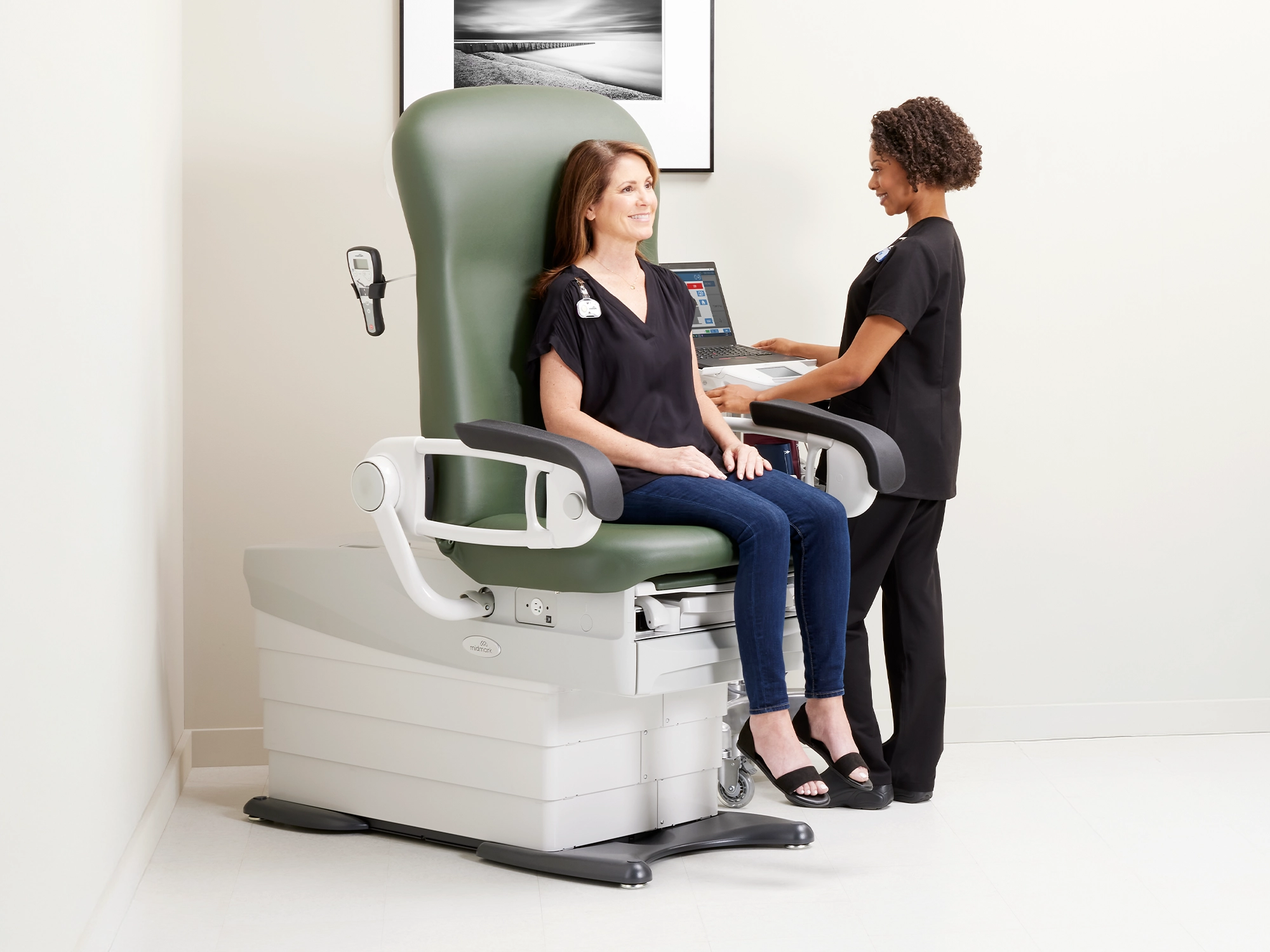 MA weighing patient in Midmark 626 Exam Chair