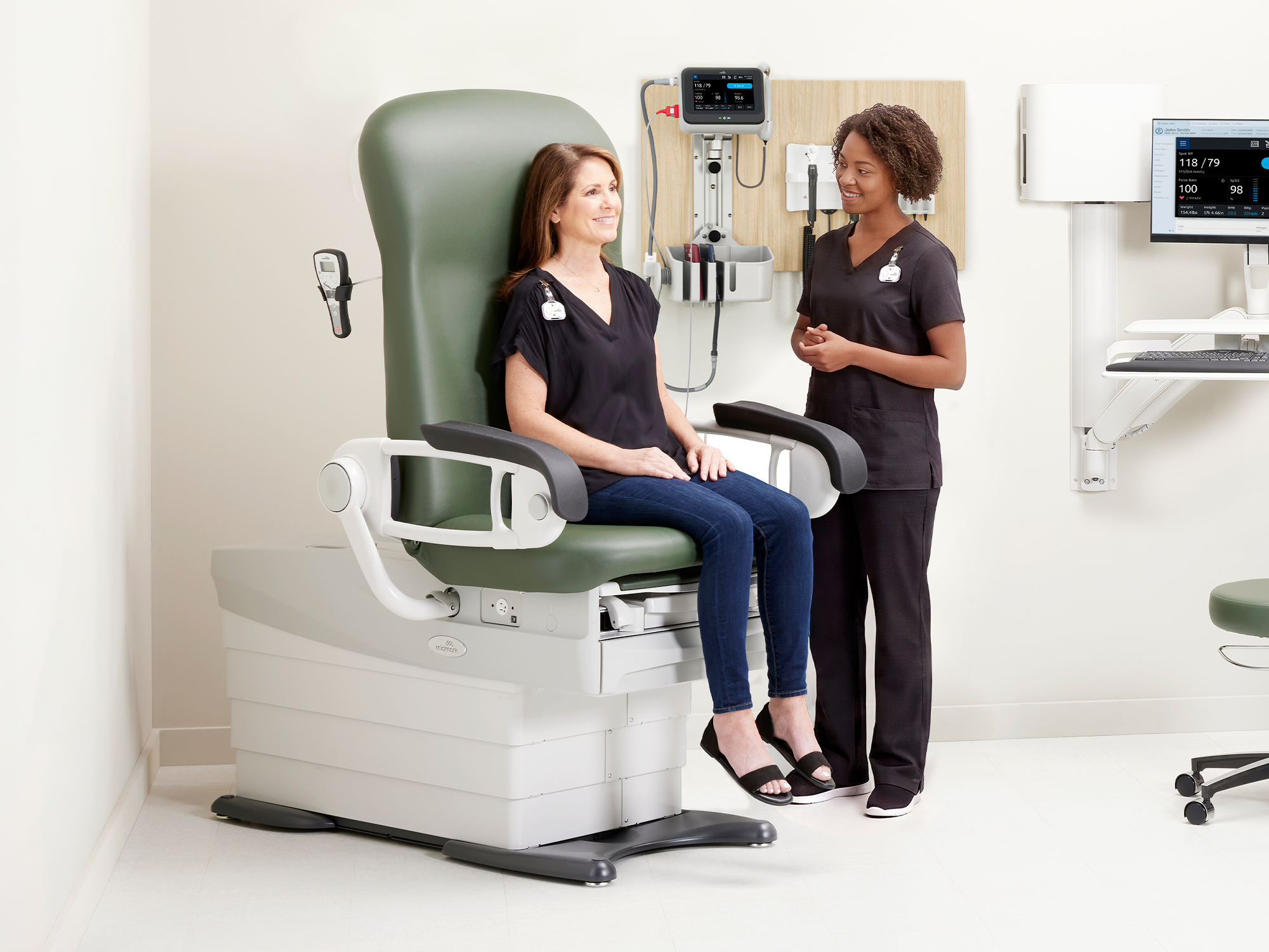 MA weighing patient in Midmark 626 Exam Chair