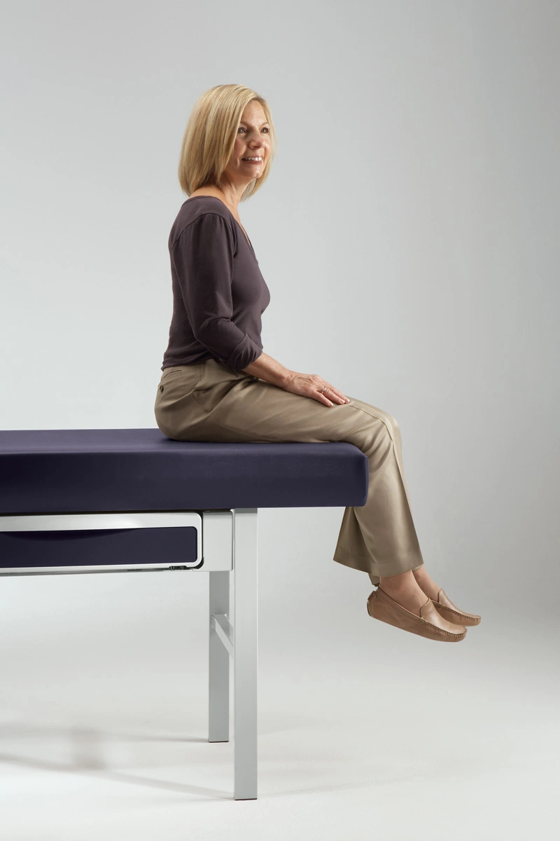 patient sitting on midmark medical examination table