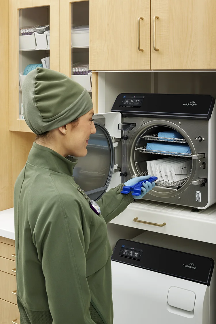 MA using hand tool to pull out sterilizer tray