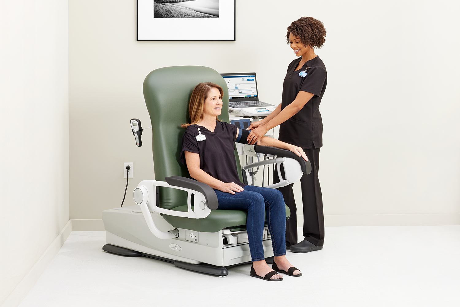 MA taking patients blood pressure using Midmark's IQvital Zone