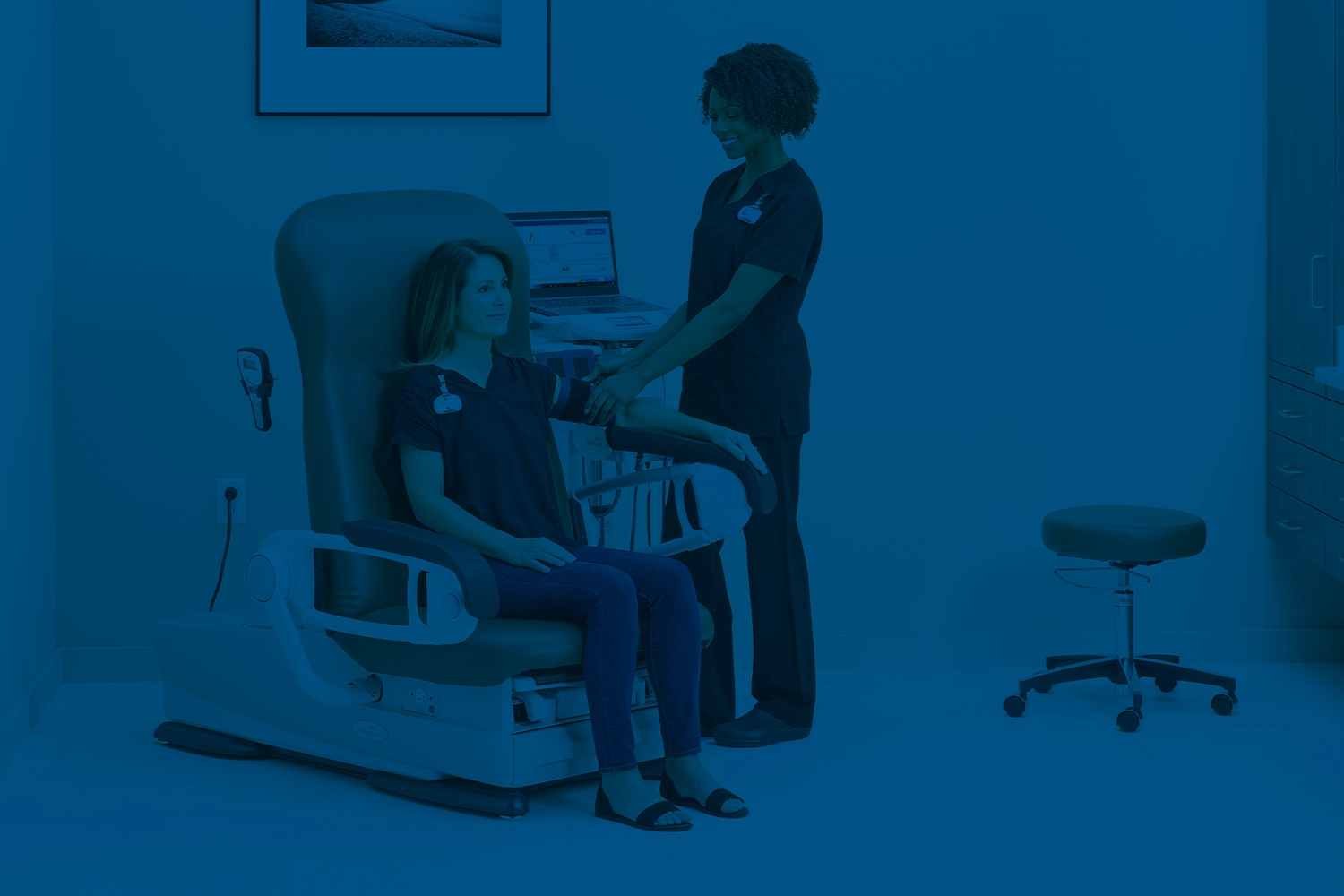 MA placing bp cuff on patients arm