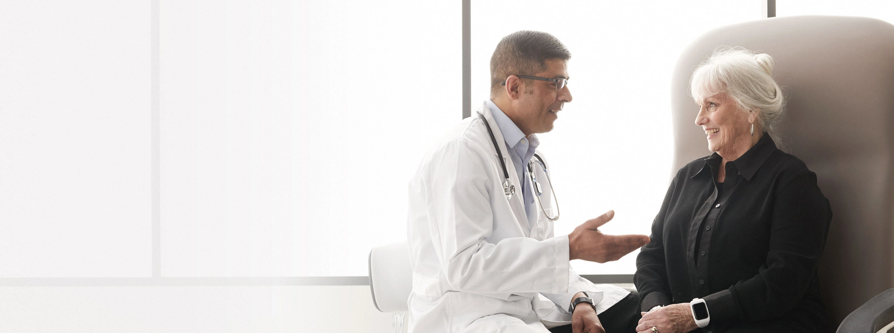 doctor helping elderly patient