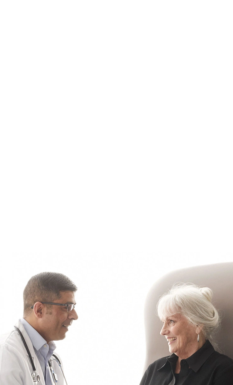 doctor helping elderly patient