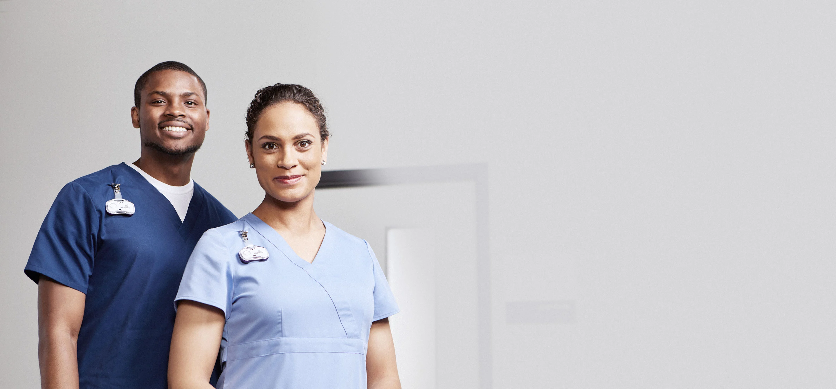 two nurses wearing midmark rtls badges