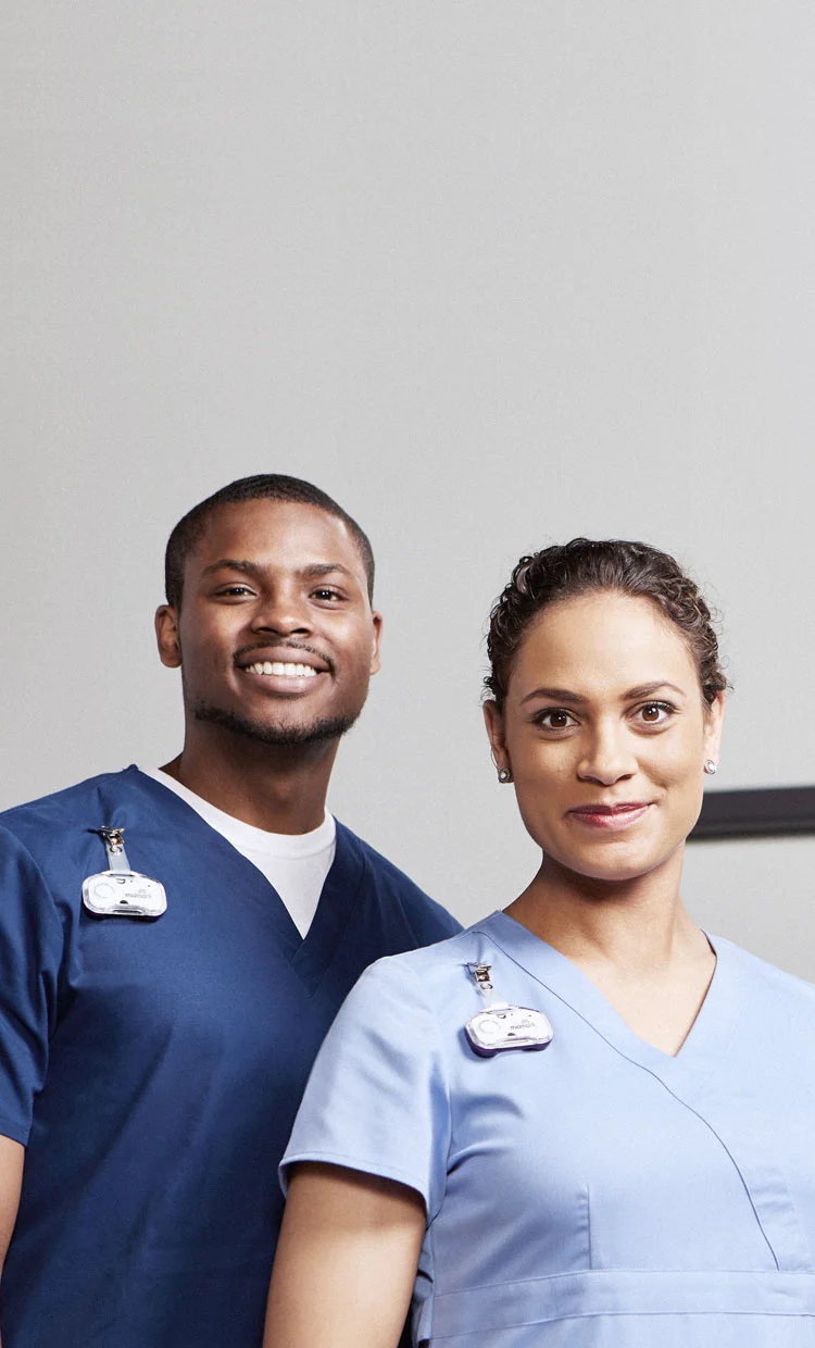 two nurses wearing midmark rtls badges