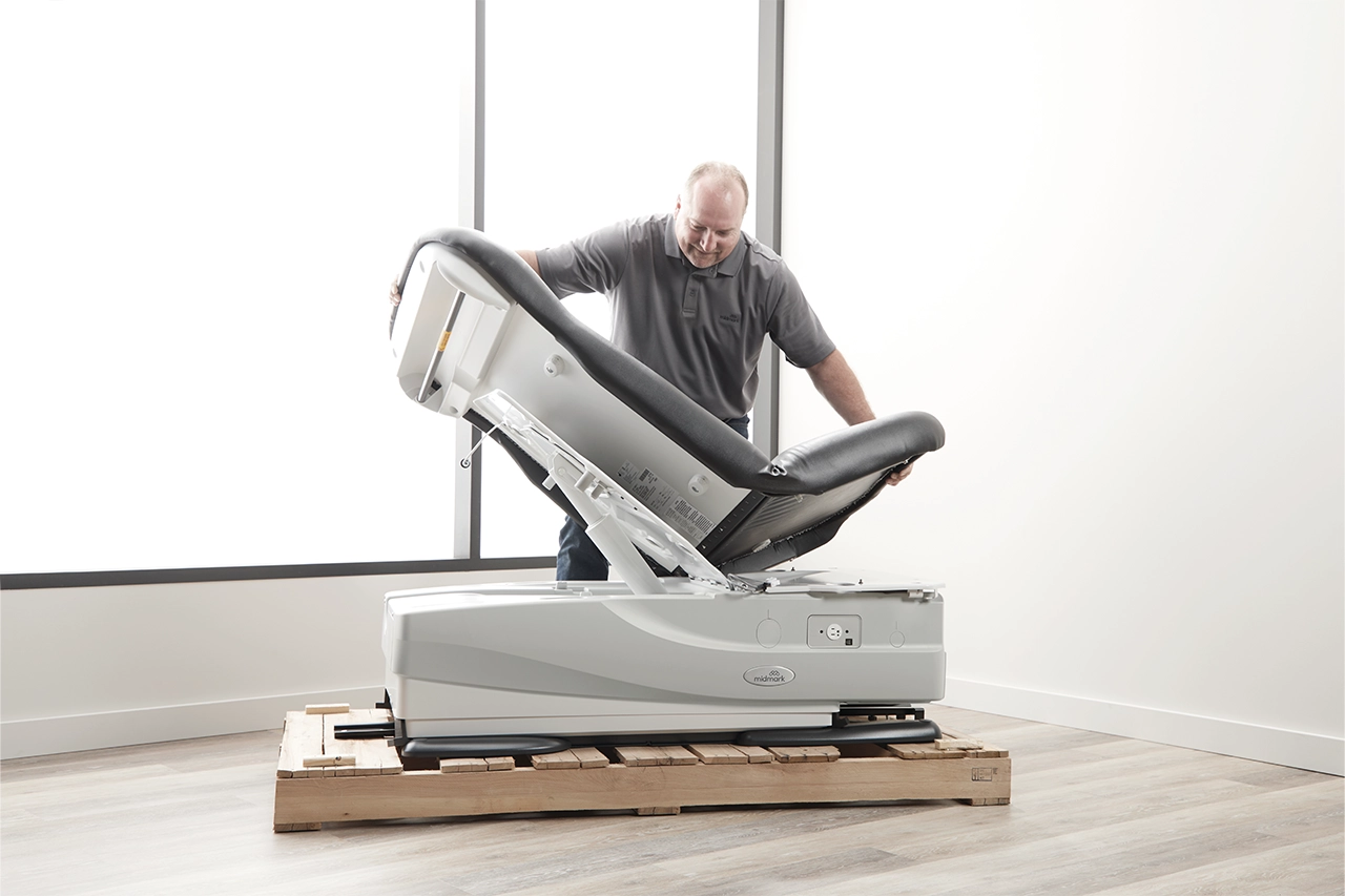 Midmark employee unpacking 626 exam chair for installation